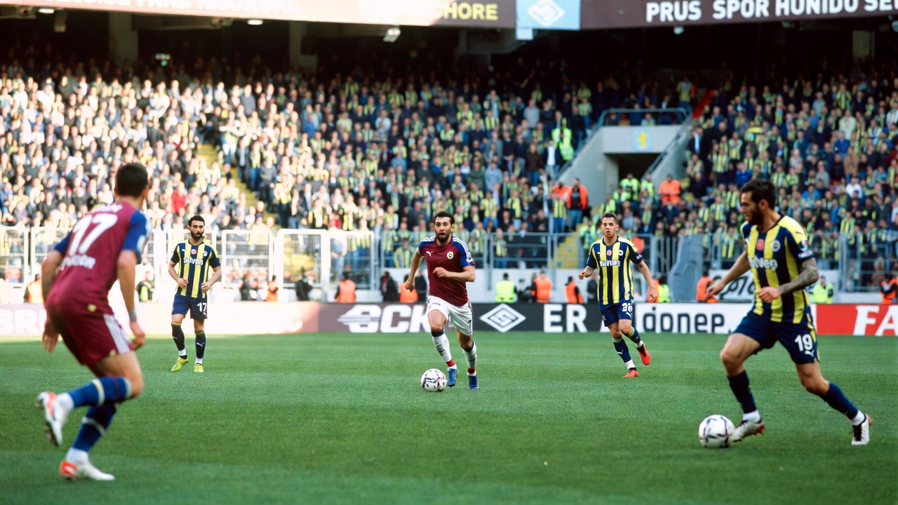 Aston Villa striker Ollie Watkins facing Fenerbahçe defense in a tense football moment at the stadium.