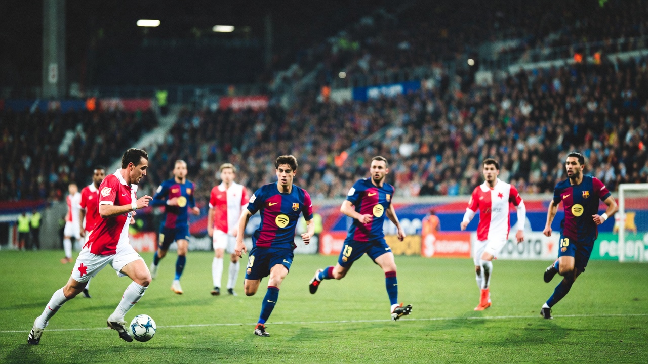 Action shot from Slavia Prague vs Barcelona match, showing Robert Lewandowski scoring and Fermín López assisting, with stadium crowd and players in full motion.